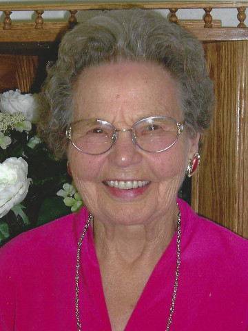 A smiling Orvina Black wearing a pink top.